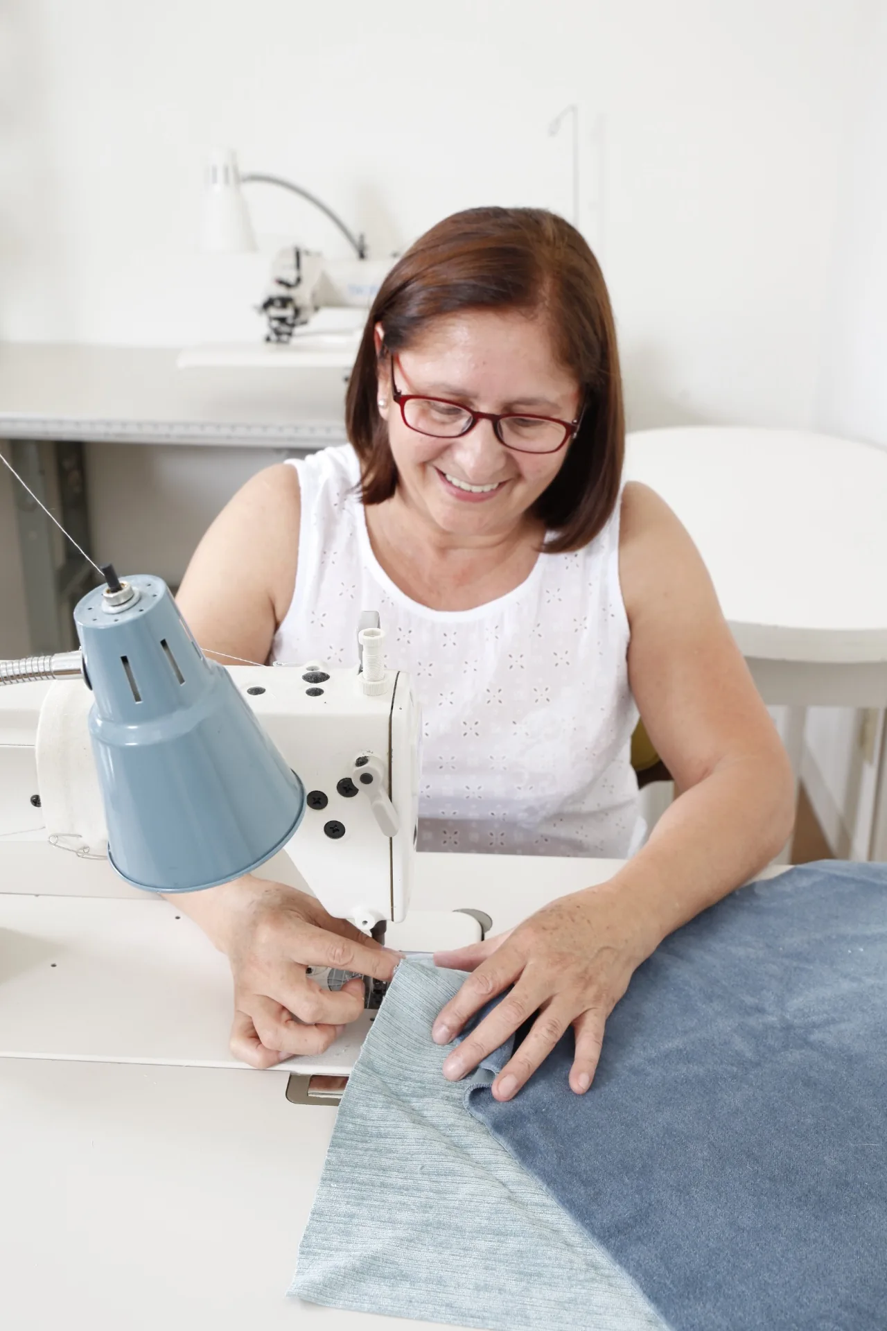Workroom owner sewing a custom soft furnishing at her machine